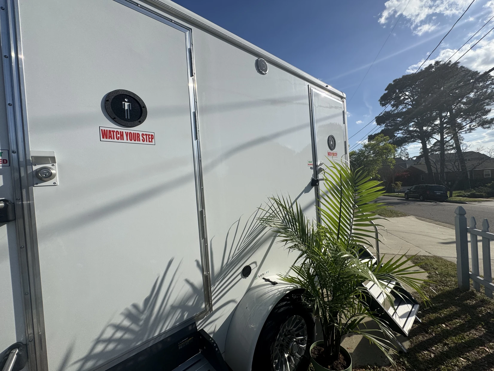 Exterior side view of the luxury restroom trailer with private stall doors